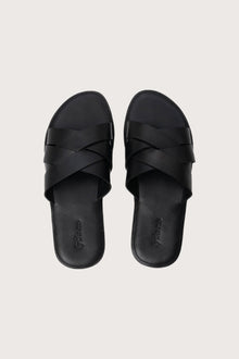 Milos sandal in nero shown in a global view highlighting its full silhouette and refined resort design