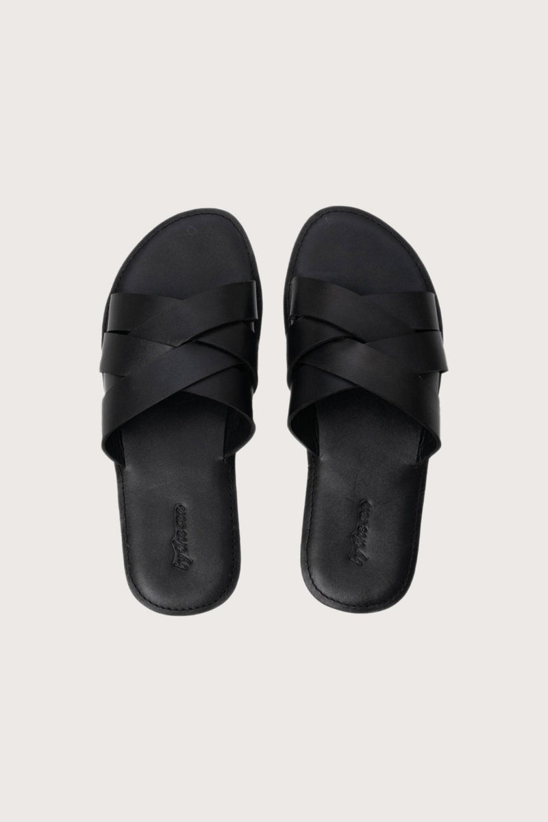 Milos sandal in nero shown in a global view highlighting its full silhouette and refined resort design