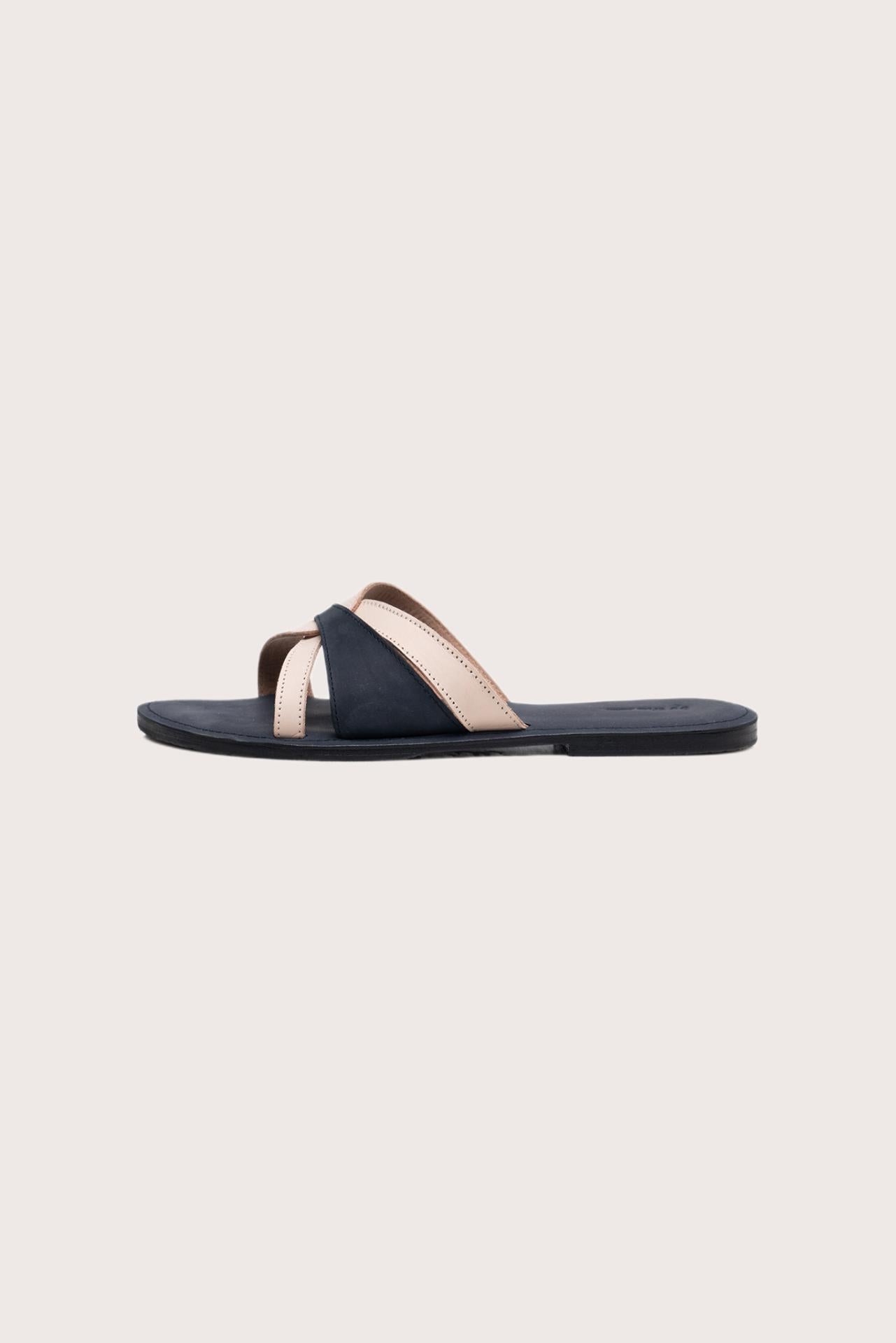 Side profile of Mina sandal in navy highlighting sleek and modern resort footwear silhouette