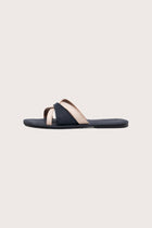 Side profile of Mina sandal in navy highlighting sleek and modern resort footwear silhouette
