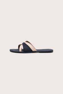 Side profile of Mina sandal in navy highlighting sleek and modern resort footwear silhouette