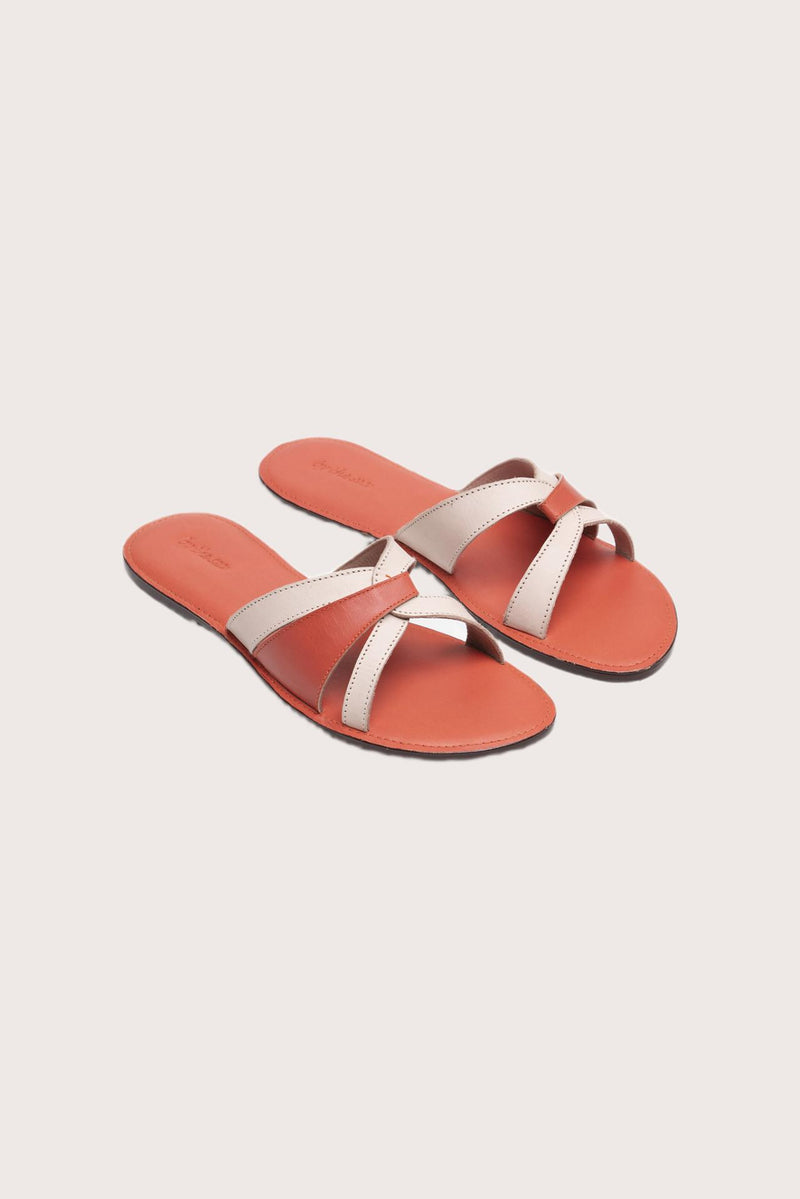 Mina sandal in orange front view showcasing elegant straps and minimalist resort aesthetic