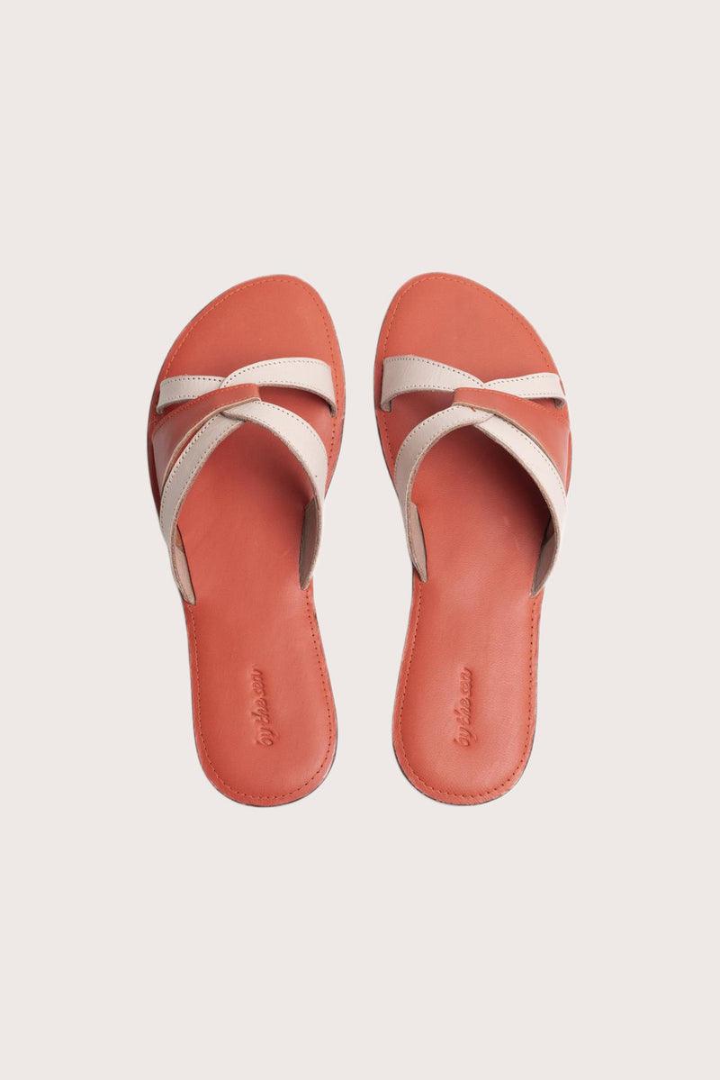 Mina sandal in orange shown in a global view highlighting its full silhouette and refined resort design