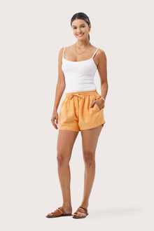 Woman wearing the Miwa Linen Short Apricot designed for effortless resortwear and tropical living by By The Sea Bali.