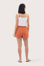 Back view of the Miwa Linen Short Coral highlighting the garment shape and drape