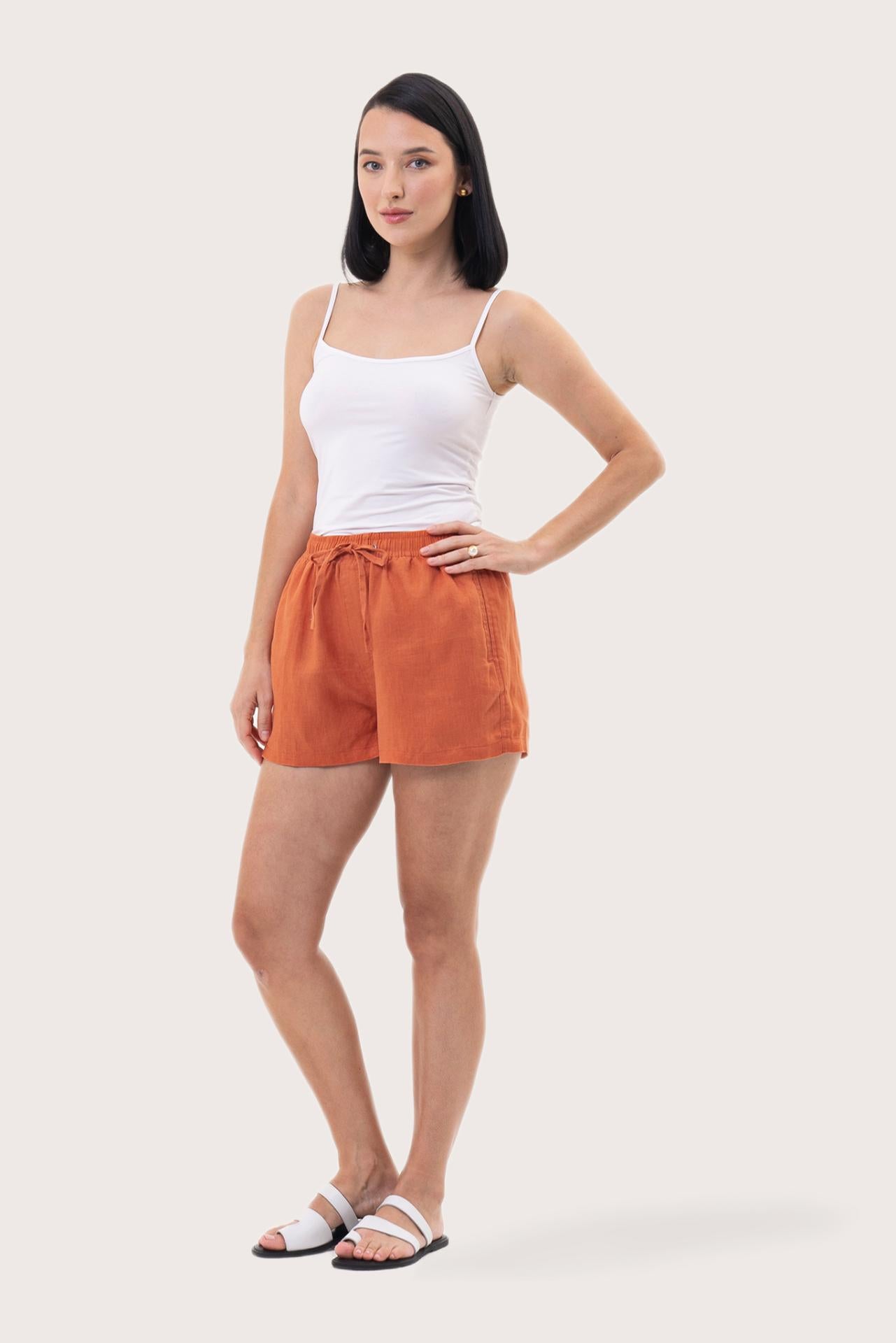 Woman wearing the Miwa Linen Short Coral designed for effortless resortwear and tropical living by By The Sea Bali.