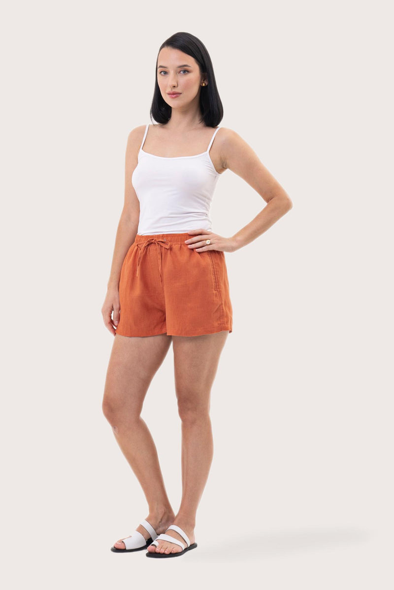 Woman wearing the Miwa Linen Short Coral designed for effortless resortwear and tropical living by By The Sea Bali.