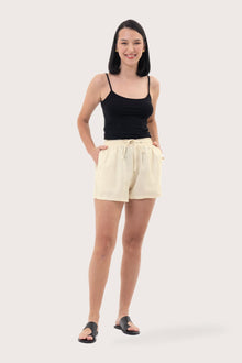 Woman wearing the Miwa Linen Short Creme designed for effortless resortwear and tropical living by By The Sea Bali.