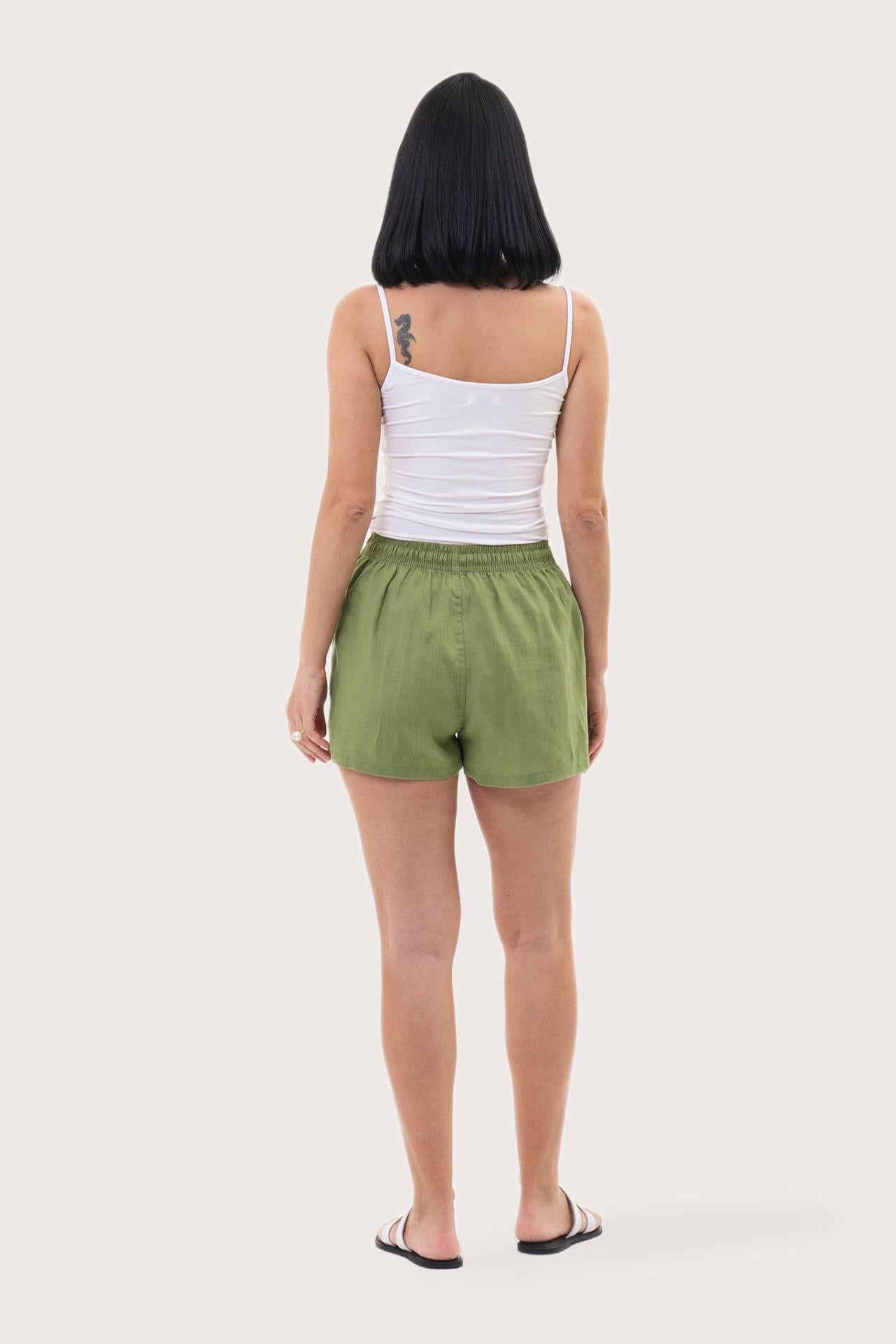 Back view of the Miwa Linen Short Green highlighting the garment shape and drape