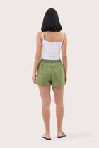 Back view of the Miwa Linen Short Green highlighting the garment shape and drape