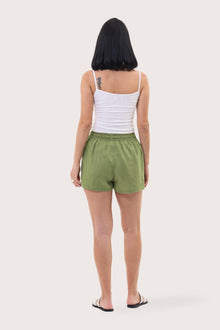 Back view of the Miwa Linen Short Green highlighting the garment shape and drape