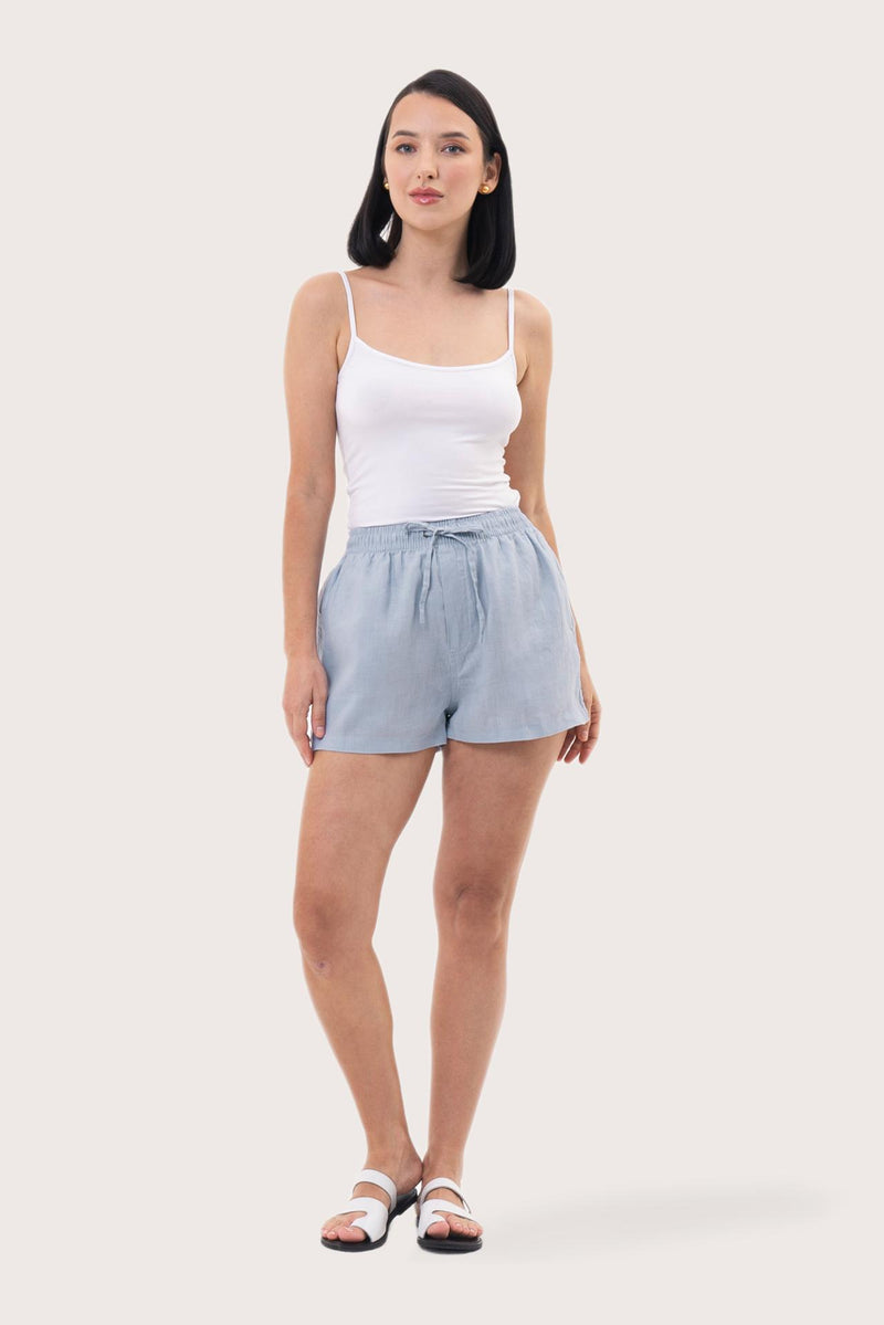 Woman wearing the Miwa Linen Short Light Blue designed for effortless resortwear and tropical living by By The Sea Bali.