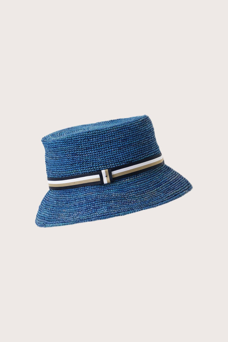 Side view of the Moa Raffia Bucket Hat Blue highlighting its soft bucket shape and lightweight construction