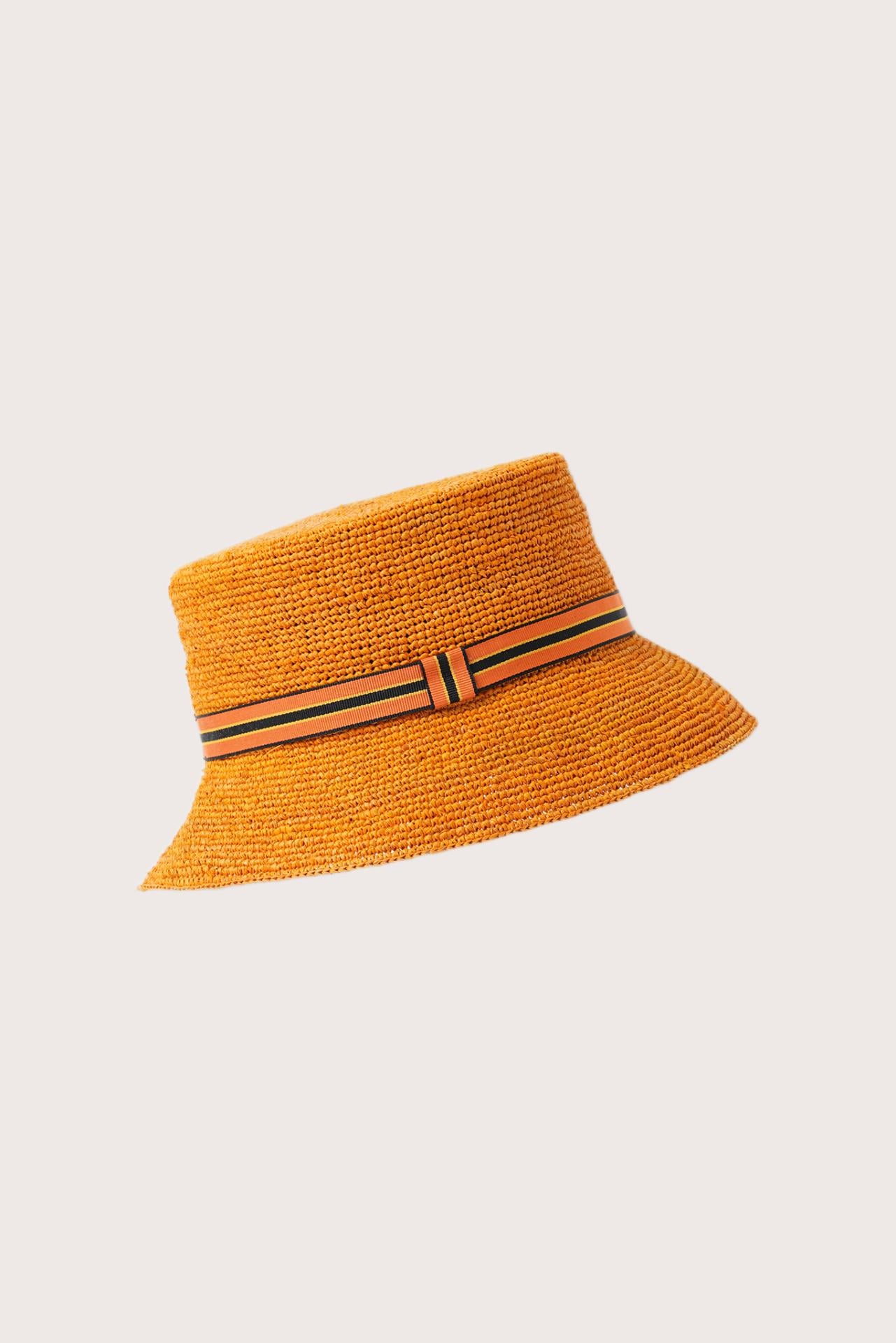 Side view of the Moa Raffia Bucket Hat Tangerine highlighting its soft bucket shape and lightweight construction