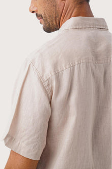 Open collar and button-front detail of the Mori Linen Shirt Kayu in Light Brown by By The Sea Bali