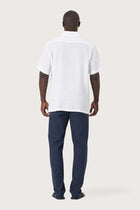 Back view of the Mori Short Sleeve Linen Shirt in White showcasing its tailored finish by By The Sea Bali