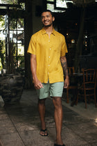 Men's resortwear styling featuring the Mori Short Sleeve Linen Shirt Gold by By The Sea Bali