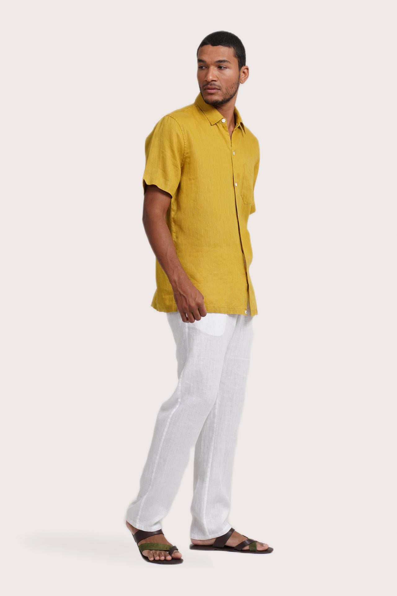 Side profile of the Mori Short Sleeve Linen Shirt Gold highlighting its easy, breathable fit by By The Sea Bali