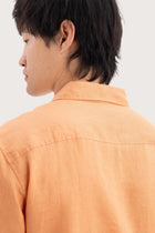 Open collar and button-front detail of the Mori Short Sleeve Linen Shirt Orange by By The Sea Bali