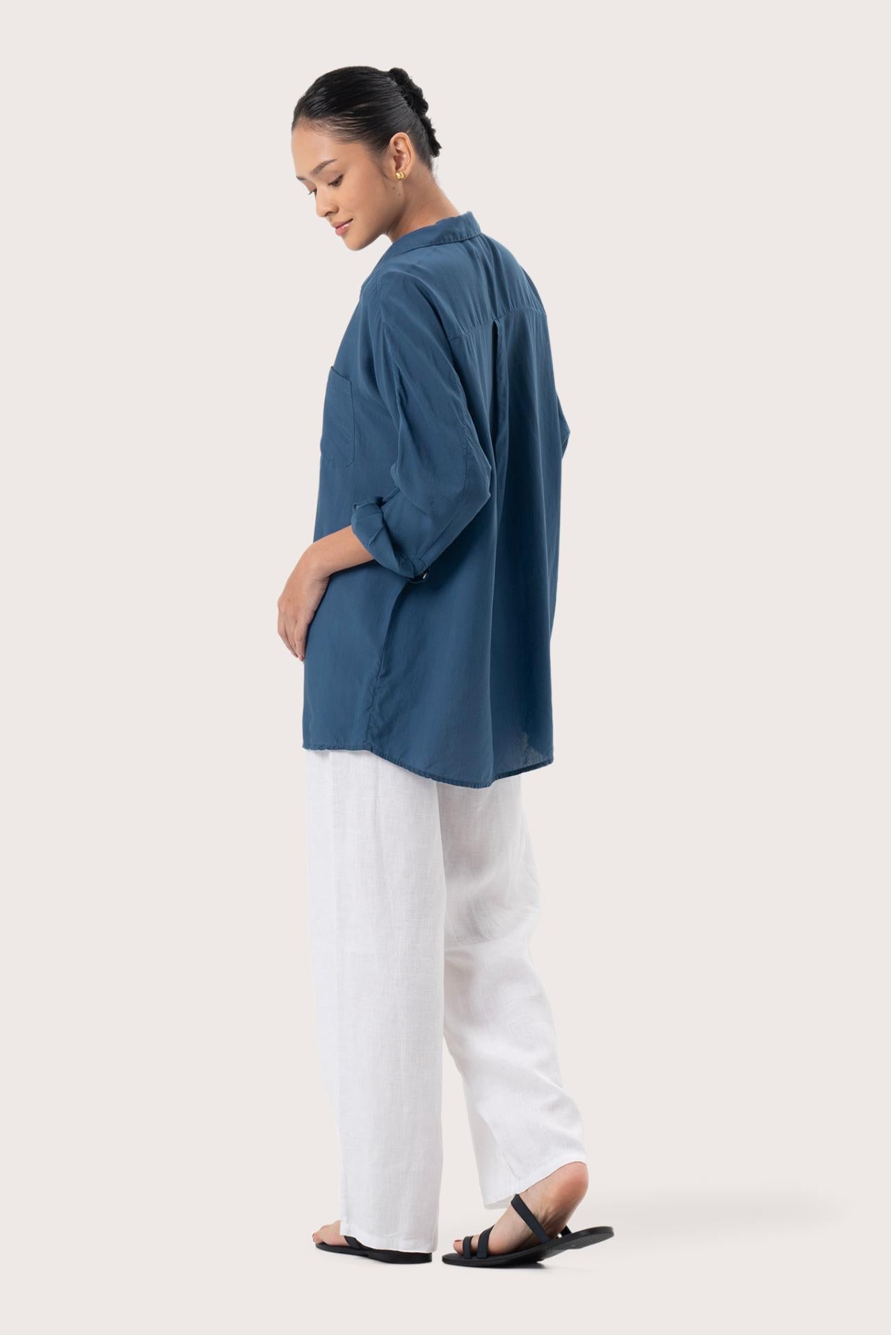Back view of the Muara Shirt Navy highlighting the garment shape and drape.