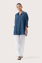 Woman wearing the Muara Shirt Navy designed for effortless resortwear and tropical living by By The Sea Bali.
