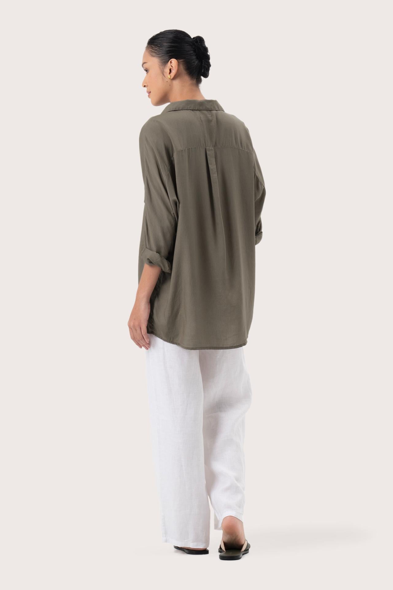 Back view of the Muara Shirt Khaki highlighting the garment shape and drape.