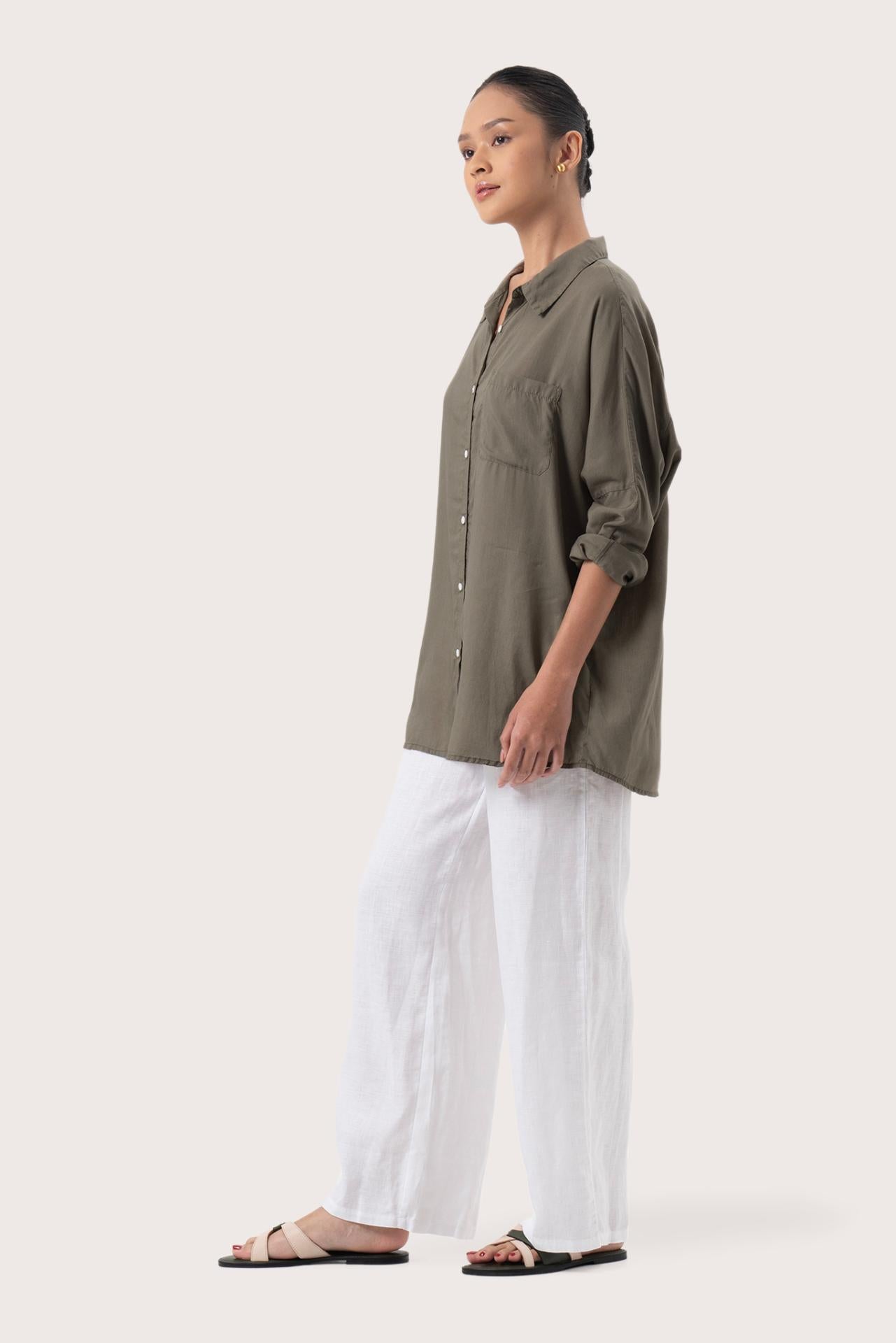 Side profile of the Muara Shirt Khaki showing its cut and natural movement.
