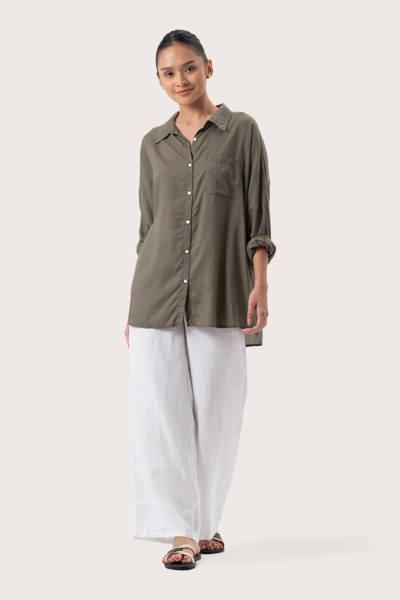Woman wearing the Muara Shirt Khaki designed for effortless resortwear and tropical living by By The Sea Bali.