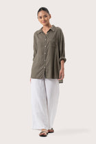 Woman wearing the Muara Shirt Khaki designed for effortless resortwear and tropical living by By The Sea Bali.