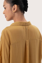 Close up detail of the Muara Shirt Mustard highlighting craftsmanship and design features.