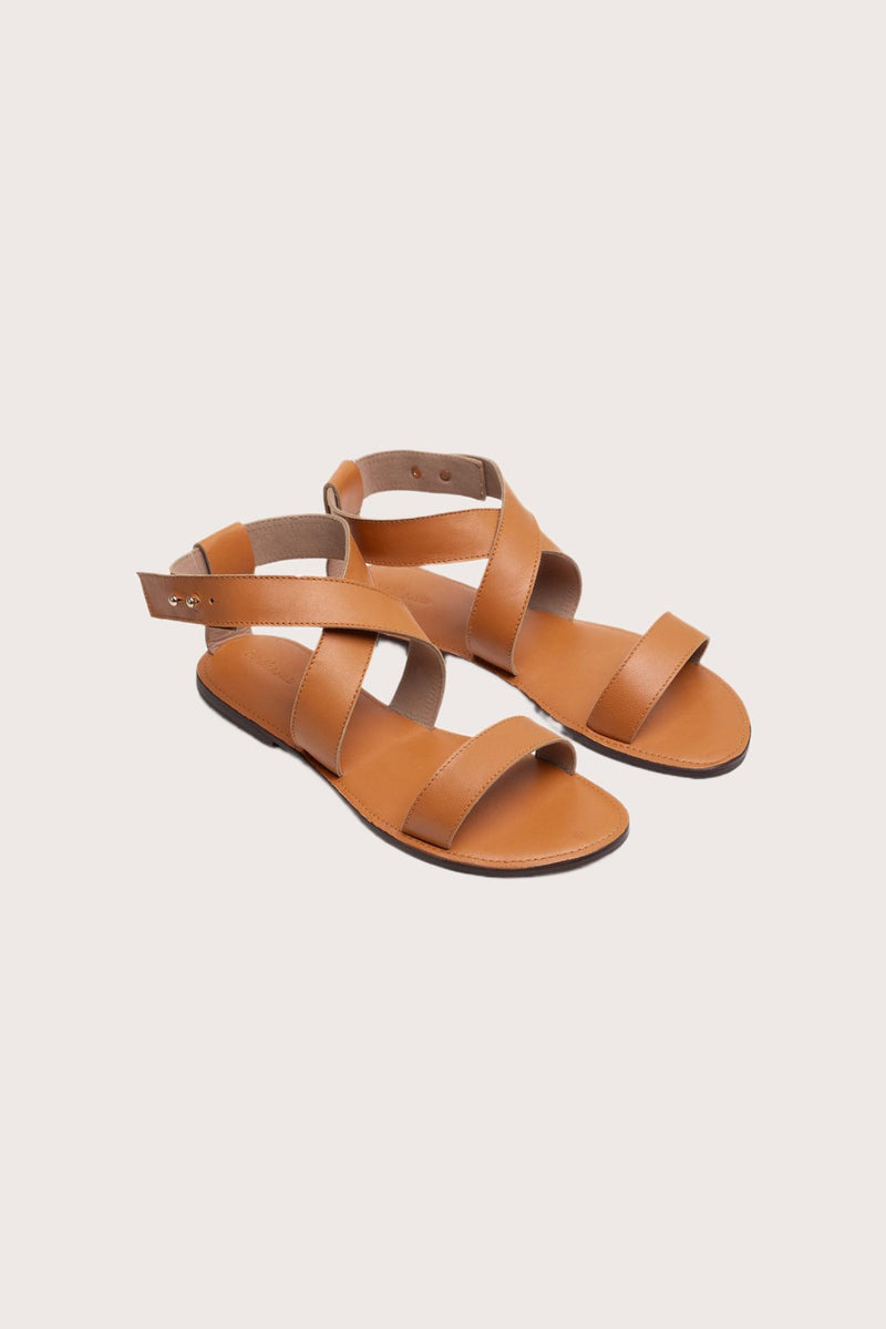Myrtle sandal in brown front view showcasing elegant straps and minimalist resort aesthetic