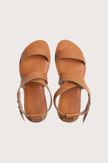 Myrtle sandal in brown shown in a global view highlighting its full silhouette and refined resort design