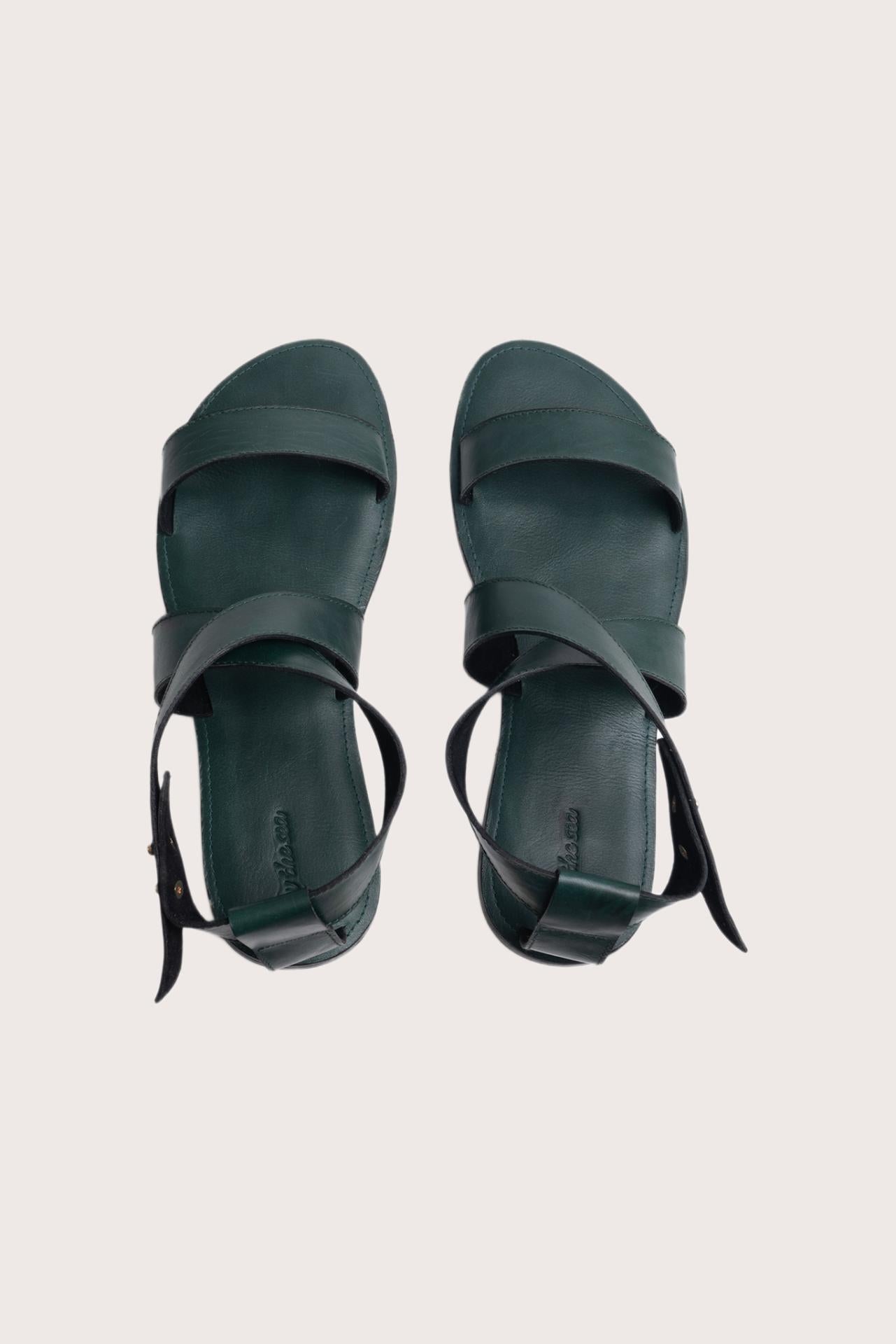 Myrtle sandal in forest green shown in a global view highlighting its full silhouette and refined resort design