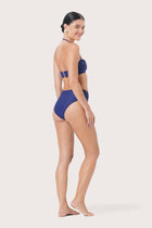 Model wearing Naia Bikini Top styled for luxury resort and beachwear