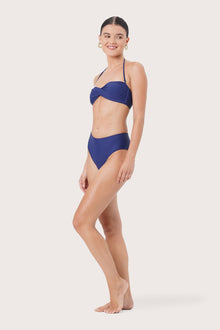Side view of Naia Bikini Top highlighting its sleek swimwear profile