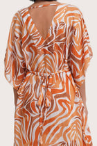 Close-up of the exclusive Leopard Orange print and tailored detail on the Nami Kaftan