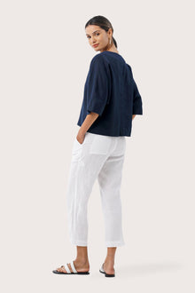 Back view highlighting the lightweight linen fabric, relaxed drape and minimalist silhouette