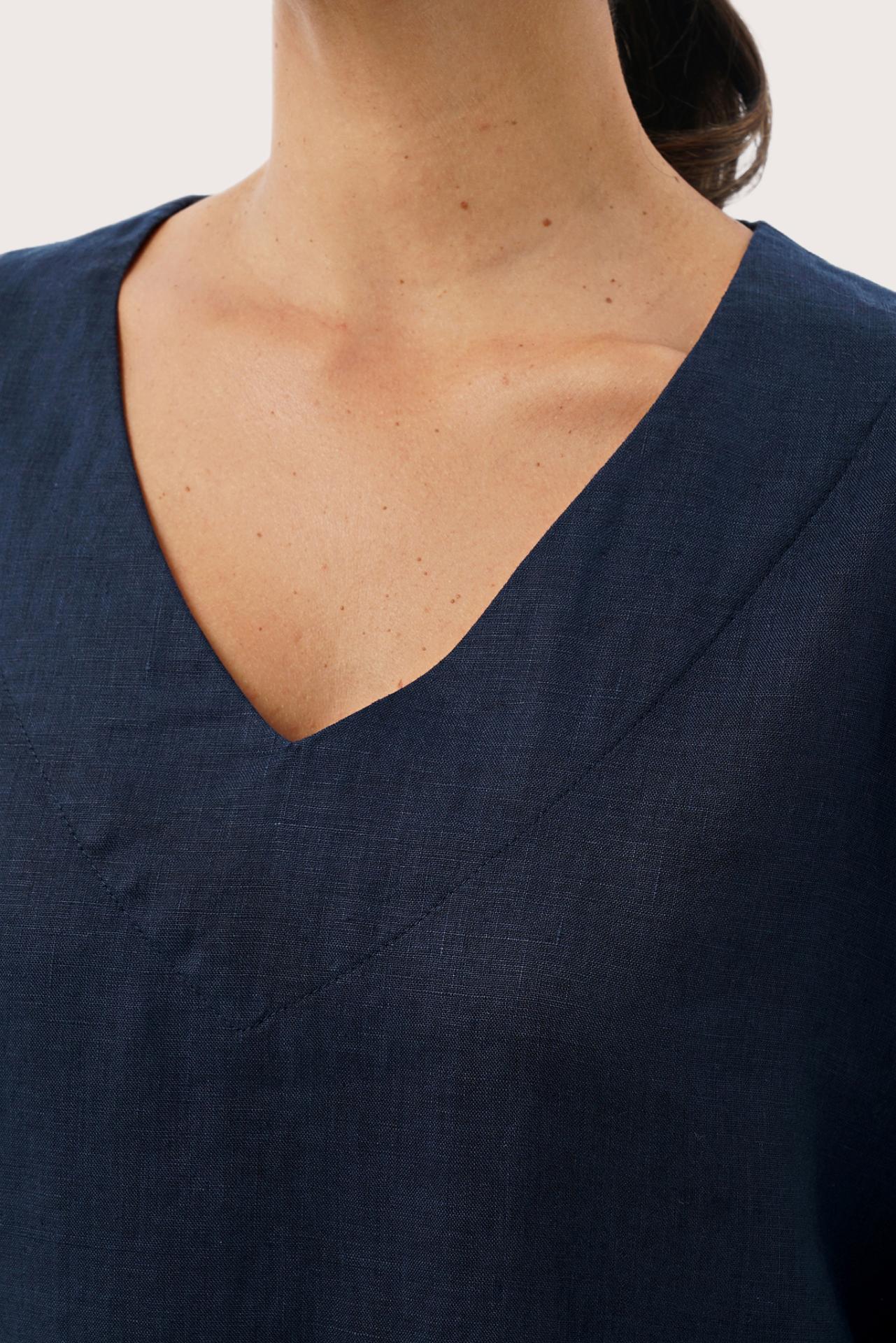 Close-up of the neckline showcasing clean tailoring and refined finishing