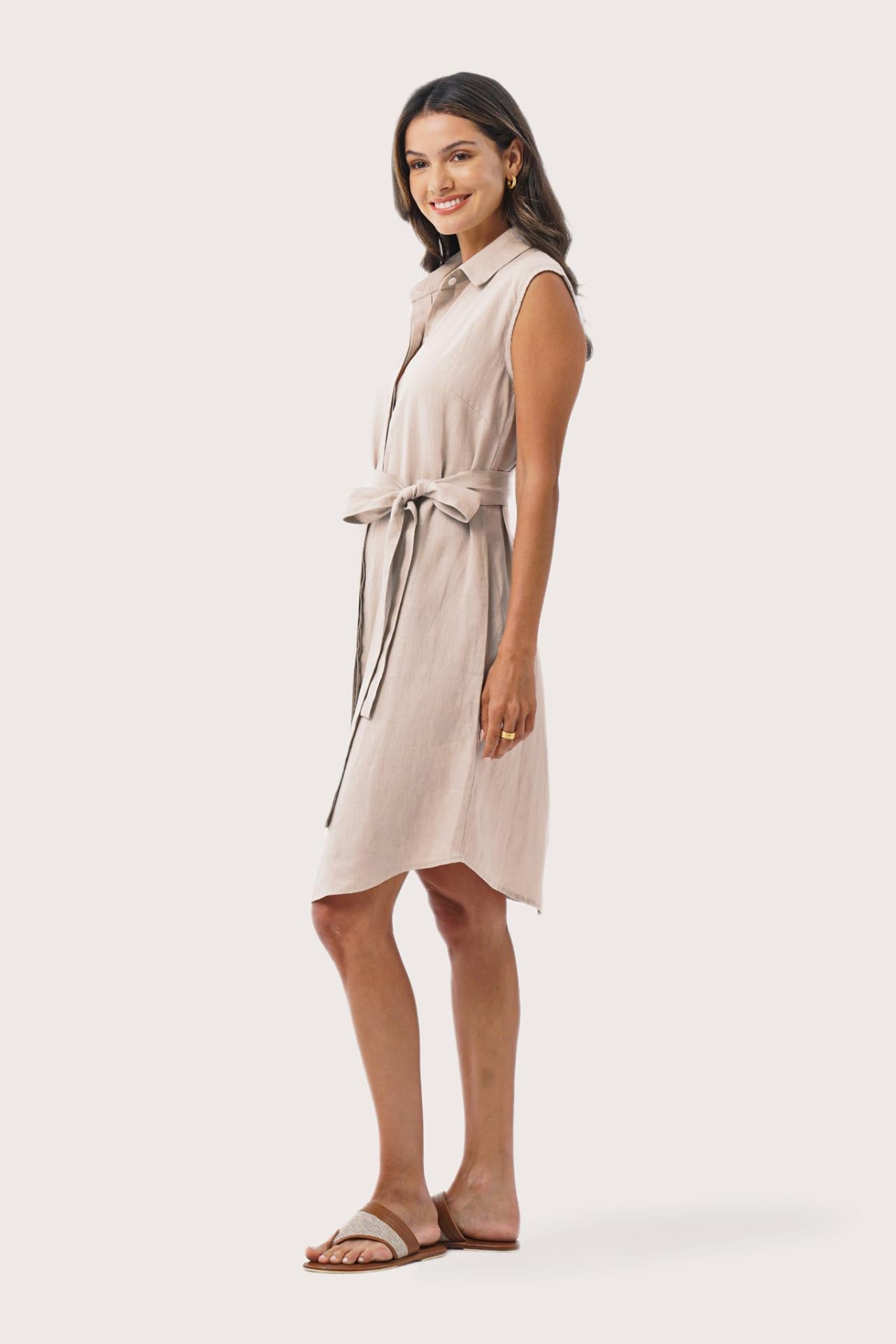 Side profile of the Noelani Sleeveless Linen Dress Beige highlighting the garment shape and drape