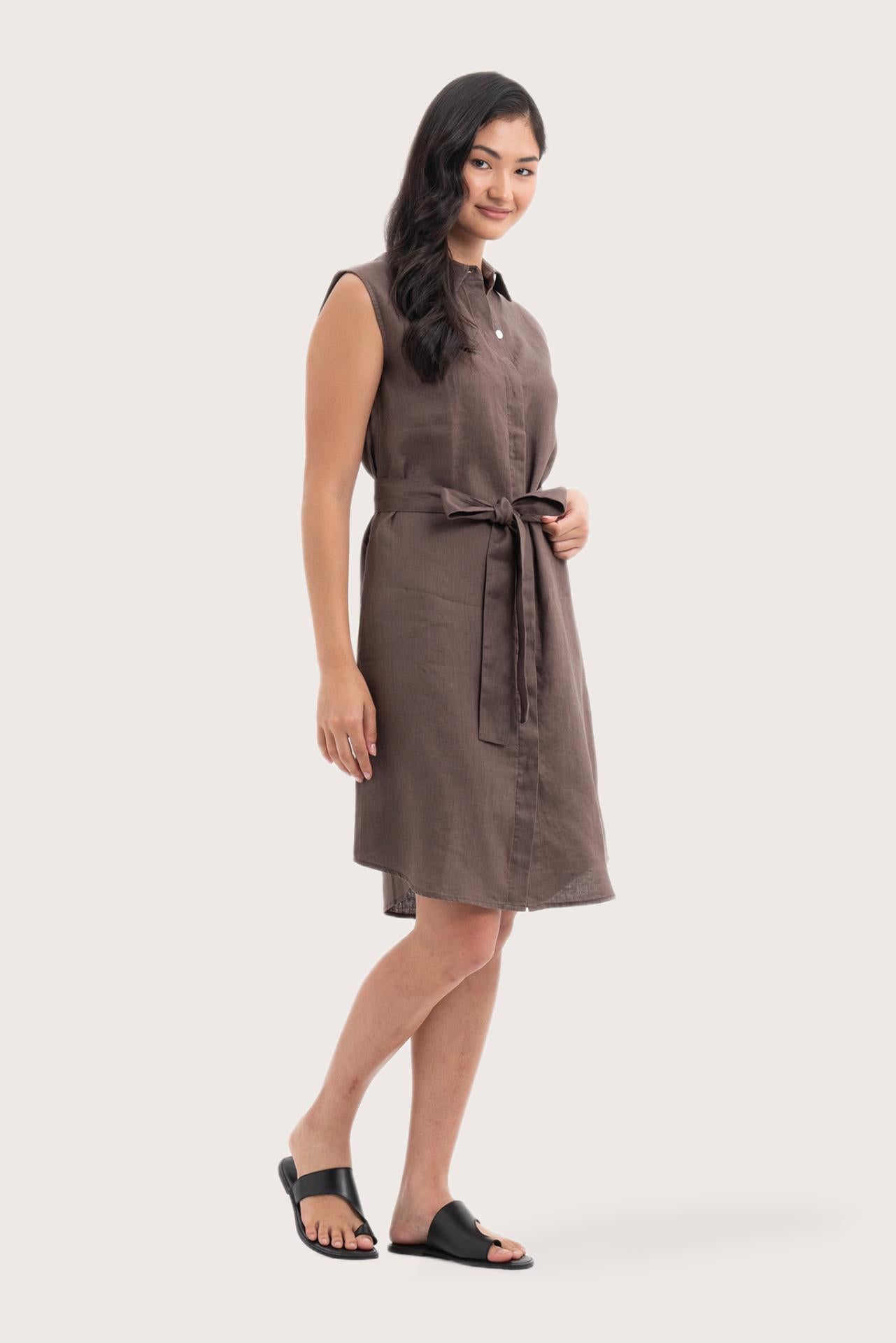 Side profile of the Noelani Sleeveless Linen Dress Dark Brown showing its cut and natural movement