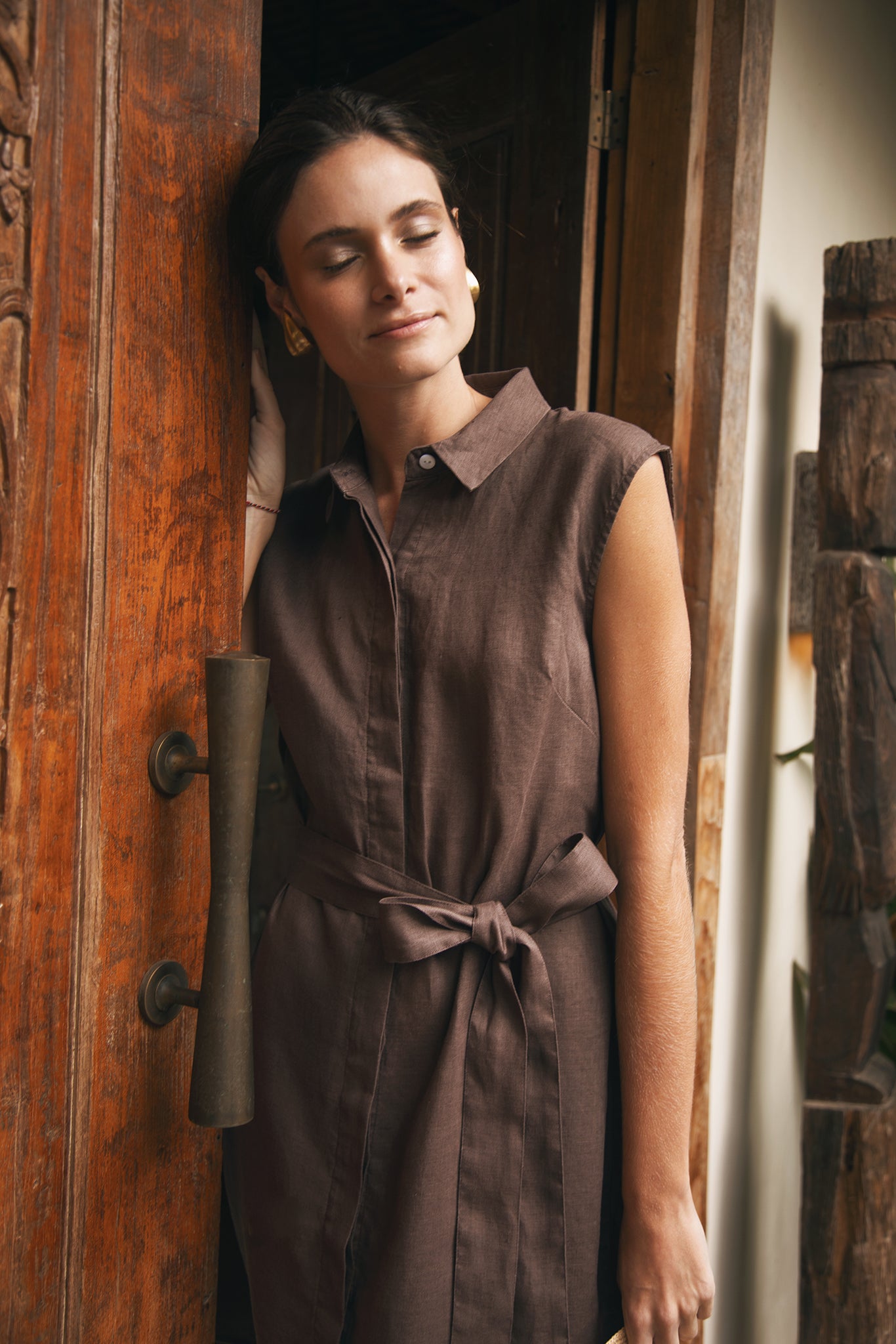 Woman wearing the Noelani Sleeveless Linen Dress Navy designed for effortless resortwear and tropical living by By The Sea Bali