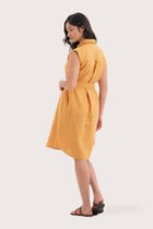 Back view of the Noelani Sleeveless Linen Dress Tangerine highlighting the garment shape and drape