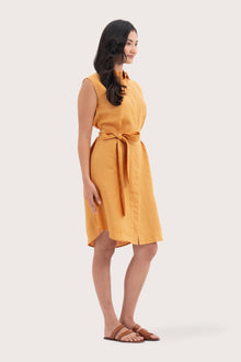 Side profile of the Noelani Sleeveless Linen Dress Tangerine showing its cut and natural movement
