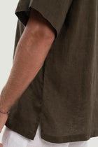 Detailed back view highlighting the relaxed silhouette and linen craftsmanship