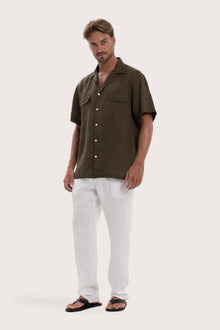 Side profile of the army linen shirt showcasing its effortless drape and comfortable fit