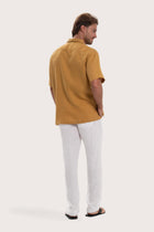 Back view of the yellow linen shirt with a relaxed and timeless silhouette