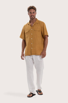Model wearing the yellow linen Odyssey shirt by By The Sea Bali