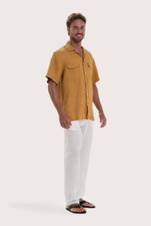 Side profile of the yellow linen shirt showcasing its effortless drape and comfortable fit