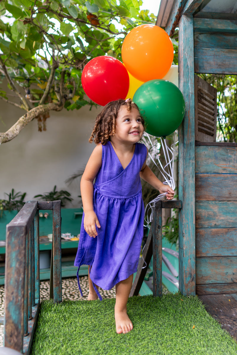 Charming resort styling featuring the Ortun Linen Kids Dress in Purple