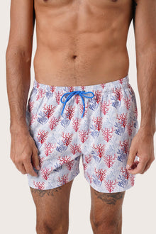 Men's beachwear styling featuring the Paco Swim Trunk in Coral Light Blue by By The Sea Bali